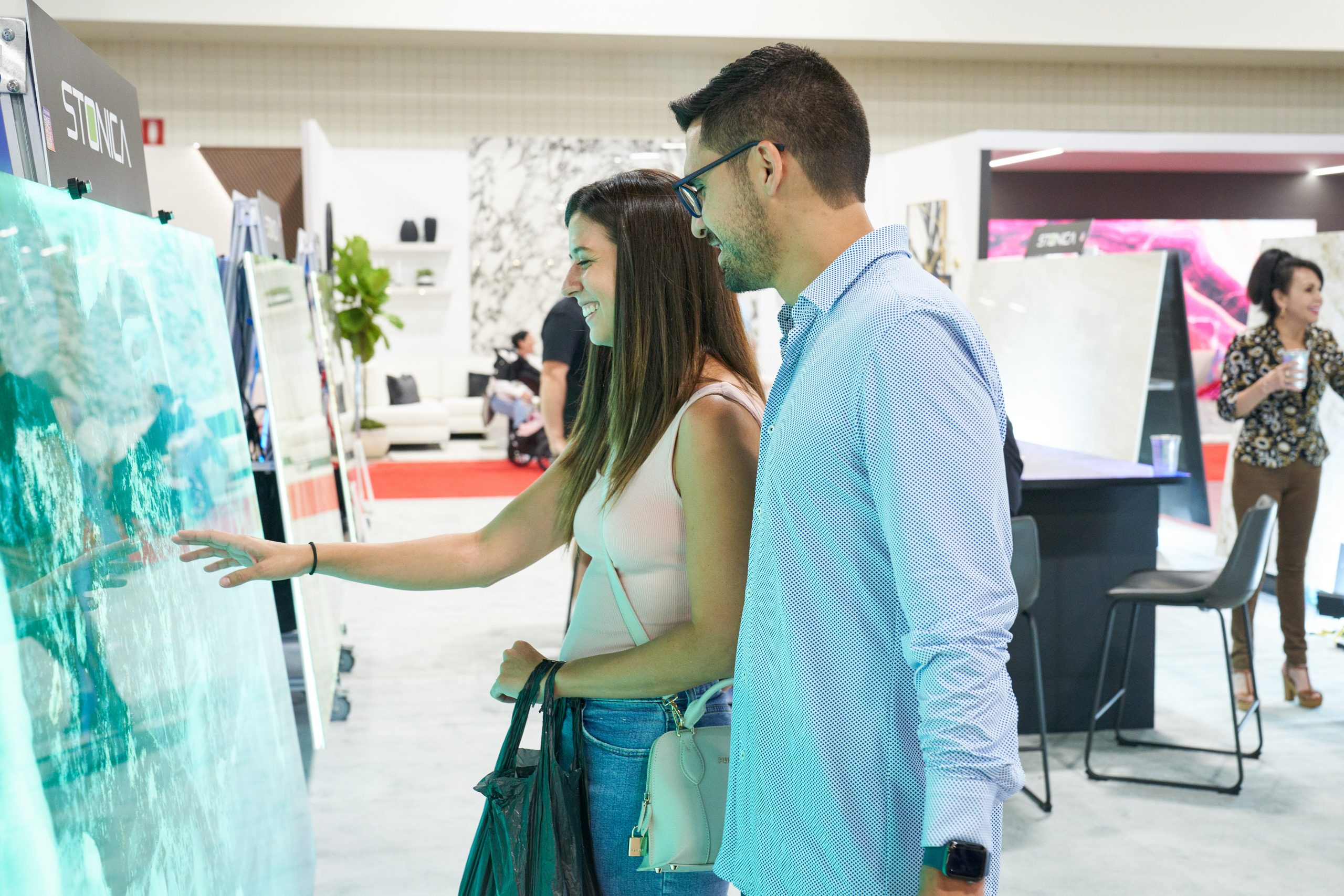 Visitors discussing design products at the Home Design and Remodeling Show.