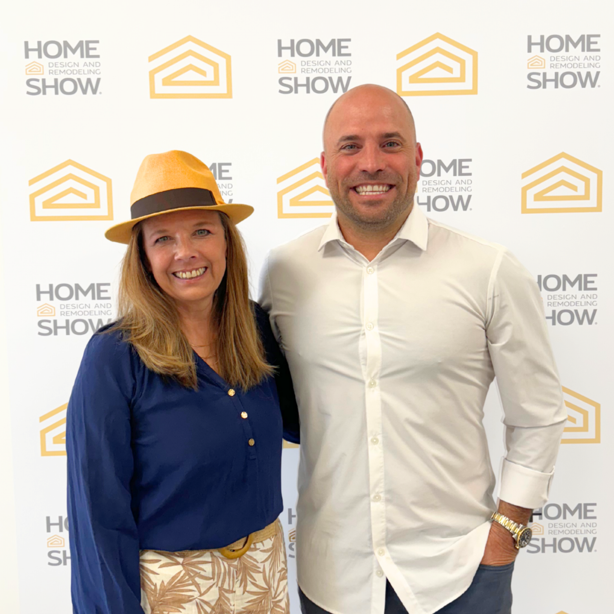 Woman speaking on stage wearing a hat during a presentation at the Home Design and Remodeling Show.