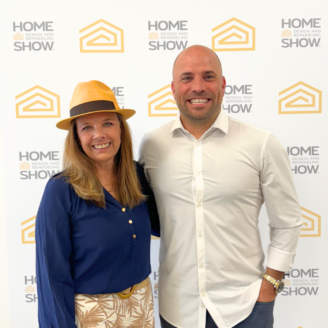 Woman speaking on stage wearing a hat during a presentation at the Home Design and Remodeling Show.