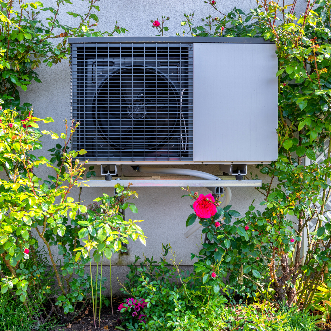 Outdoor air conditioning unit surrounded by plants featured in the Home Design and Remodeling Show energy efficiency display.