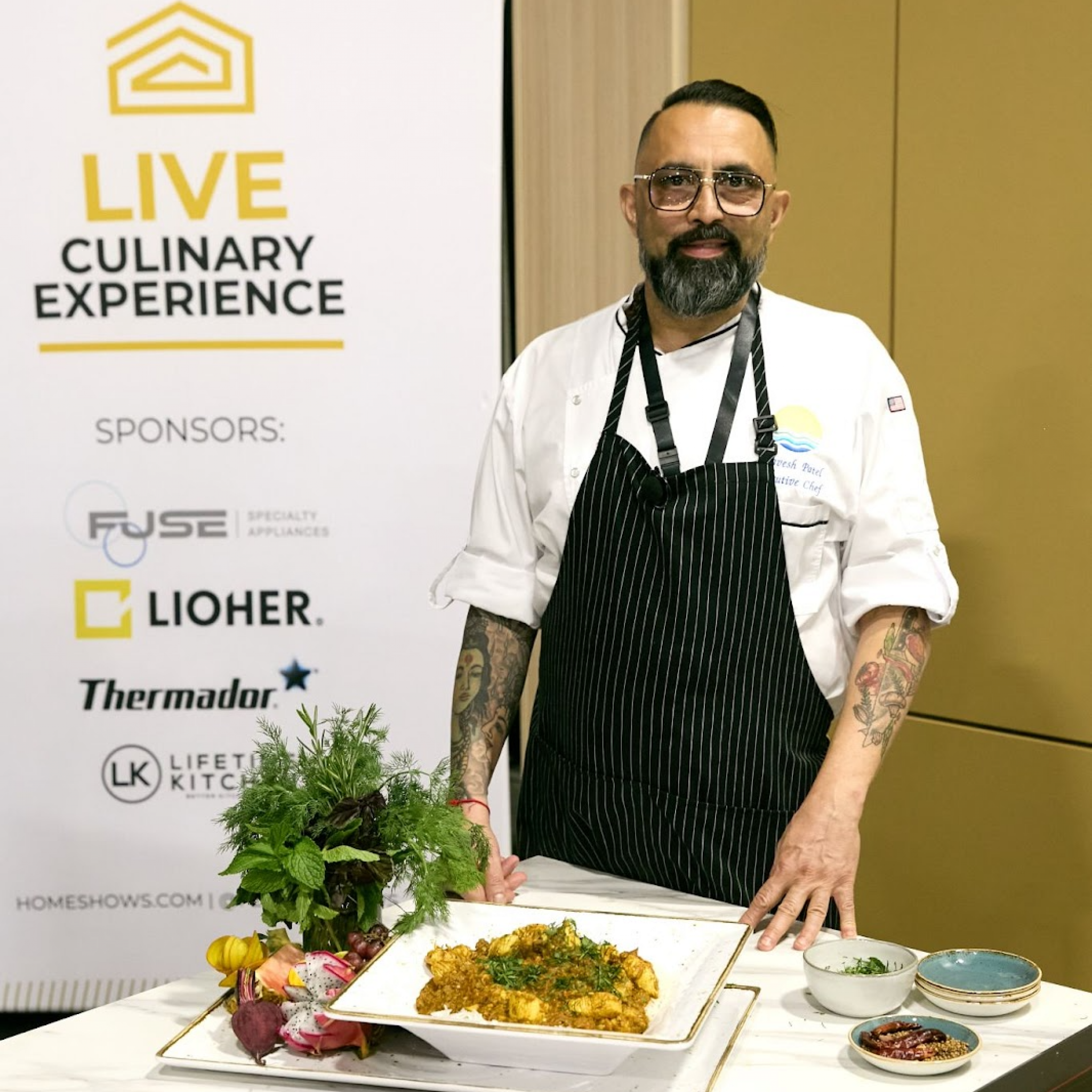 Chef presenting plated dishes at the Live Culinary Experience sponsored by LiOher.