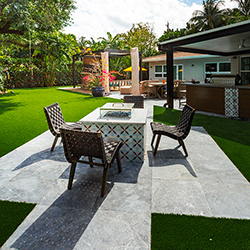 Outdoor entertainment space featuring a bar and pergola with modern lighting at the Home Design and Remodeling Show.