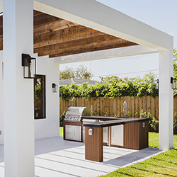 Contemporary backyard setup with outdoor furniture and green lawn displayed at the Home Design and Remodeling Show.