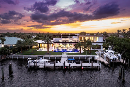 Outdoor waterfront lounge setup at sunset featured in the Home Design and Remodeling Show promotion.